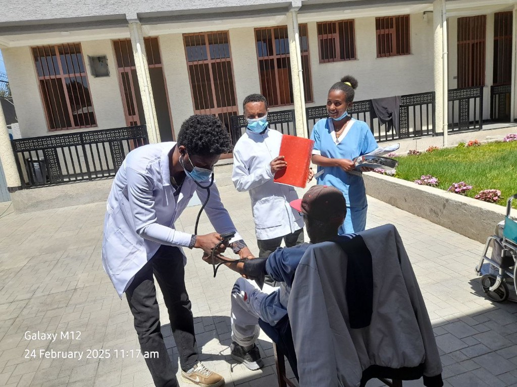 Nursing staff checking a patient's blood pressure at Enat Nursing Home